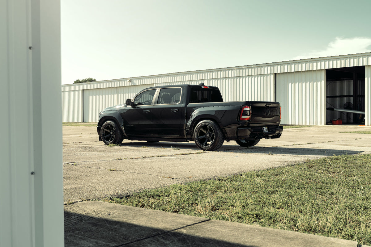RAM 1500 Crew Cab widebody kit, rear three-quarter view in front of a hangar