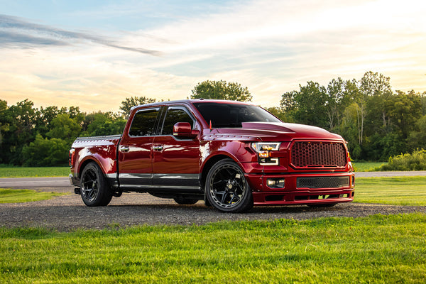 Clinched widebody kit on 2015-2017 Ford F-150, red and grey, front three-quarter close-up
