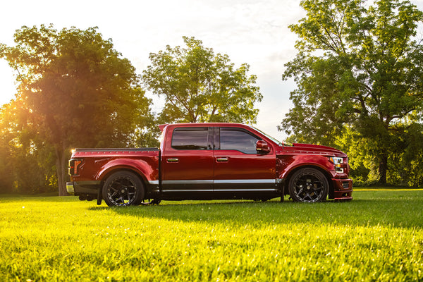 Clinched widebody kit on 2015-2017 Ford F-150, red and grey, lowered, side view